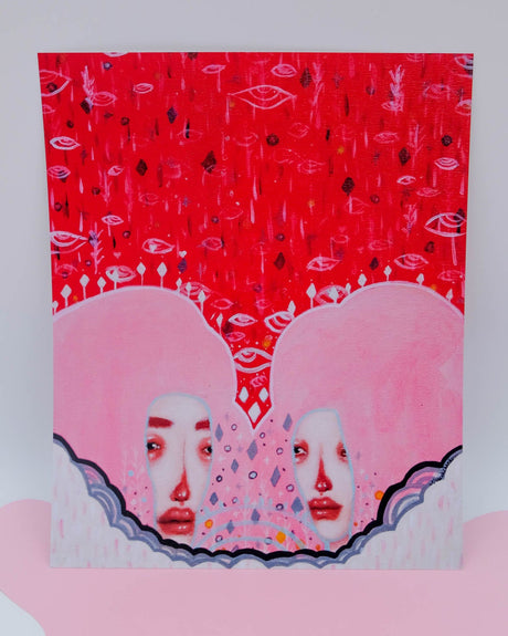 An art print featuring two stylized, abstract, red-colored faces with a white background and scattered decorative elements.