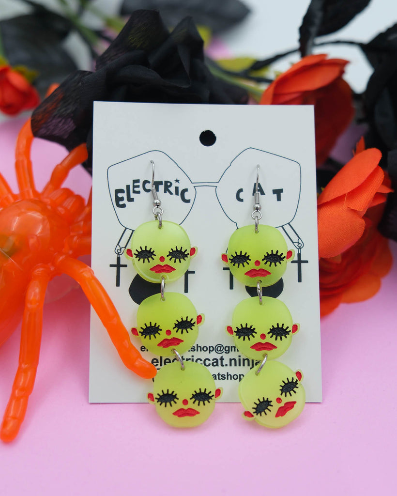 Glow in the dark acrylic creepy baby earrings by electric cat