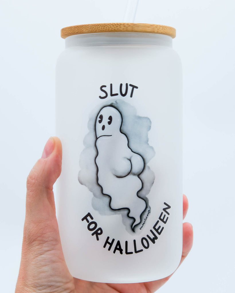 Playful ghost design with the words “Slut for Halloween” on a 16 oz frosted glass tumbler with bamboo lid and straw, sublimated by Electric Cat.