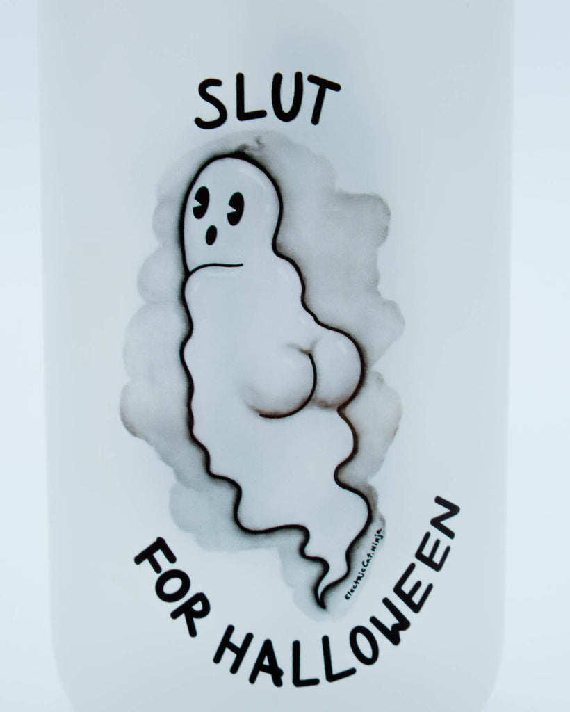 Playful ghost design with the words “Slut for Halloween” on a 16 oz frosted glass tumbler with bamboo lid and straw, sublimated by Electric Cat.
