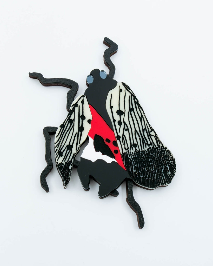 Handmade laser-cut acrylic and wood art piece showing a squashed spotted lanternfly with red and black markings, designed by Electric Cat.