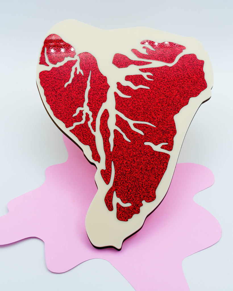 Pop art style steak sculpture made with red glitter acrylic and ivory details, handmade wall decor by Electric Cat.