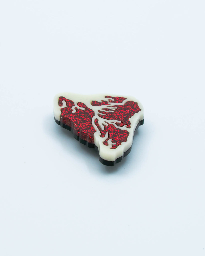 Handmade acrylic steak magnet featuring red glitter details and ivory base, crafted by Electric Cat.