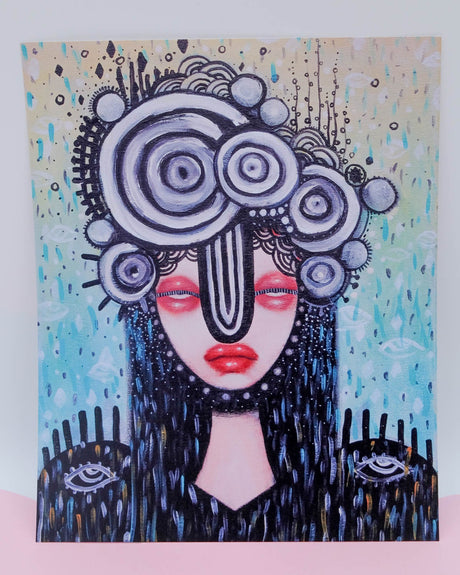 An art print featuring a stylized, abstract portrait of a female figure with a geometric backdrop.